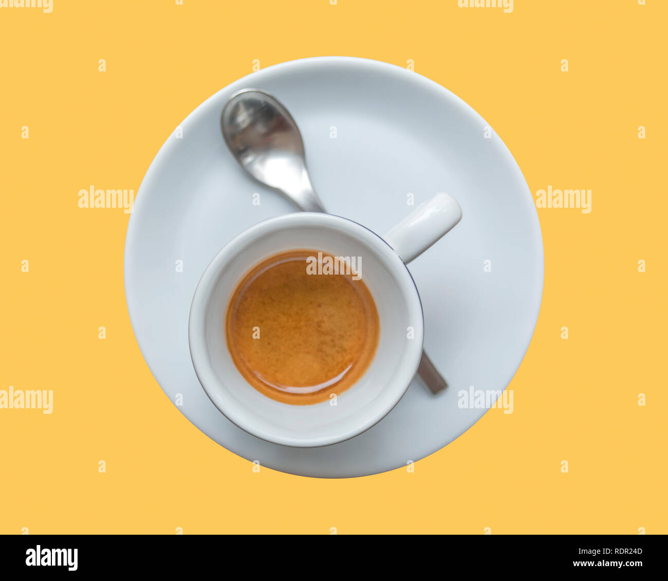 Perfect cup of espresso in white cup isolated on yellow background Stock Photo