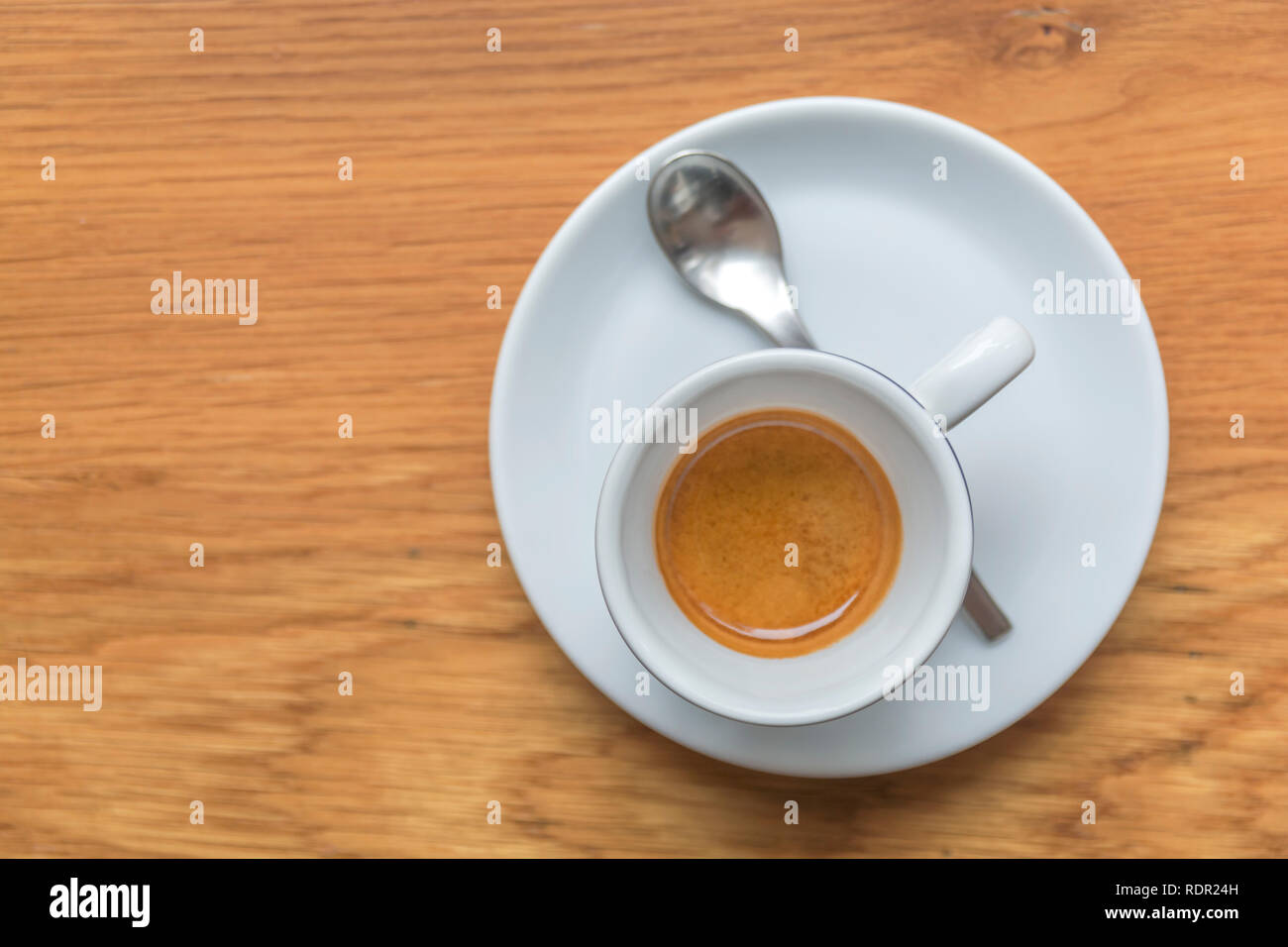 Perfect cup of espresso in white cup on wooden table Stock Photo