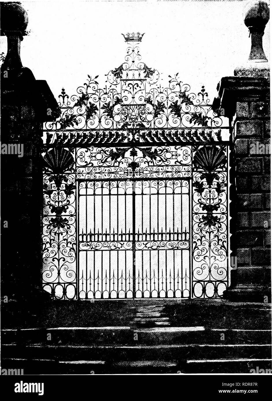 . Gardens for small country houses . Gardens, English. Gates and Gateways. 199 not fallen under the spell of Tijou or at least of his book of designs. The horizontal lines are heavily emphasised and the embossed shells at the top of the side panels are unusually prominent. The &quot;overthrow&quot; of the gate is very marked by the range of embossed acanthus leaves (derived apparently from Tijou's gadroon and acanthus border) which connect the two stout horizontals supporting the pyramid of scrollwork, etc. A rather unusual feature; is the trio of oval rings at the base of each side panel. The Stock Photo