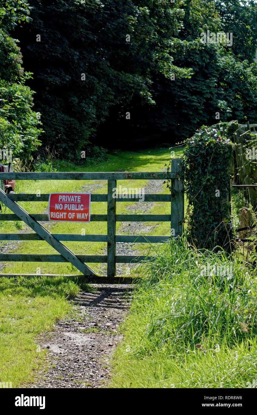 Closed gate on country lane in Scotland with private no public right of way sign Stock Photo