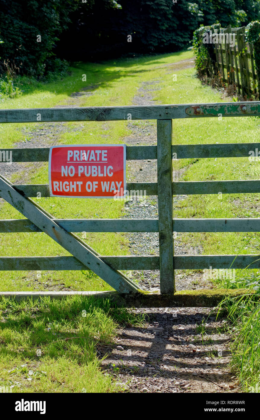Closed gate on country lane in Scotland with private no public right of way sign Stock Photo