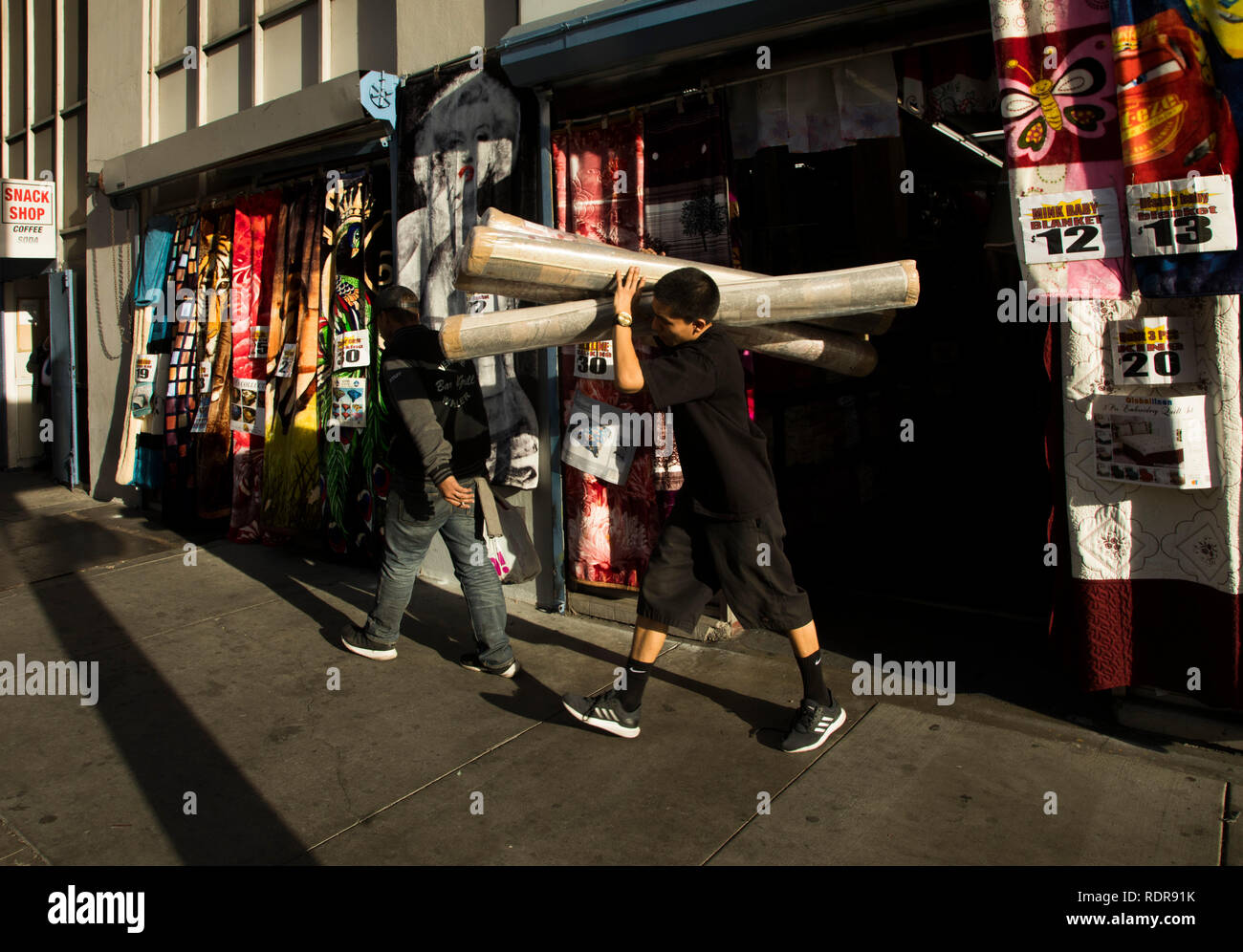 Worker, textile store, downtown Los Angeles, California, USA Stock
