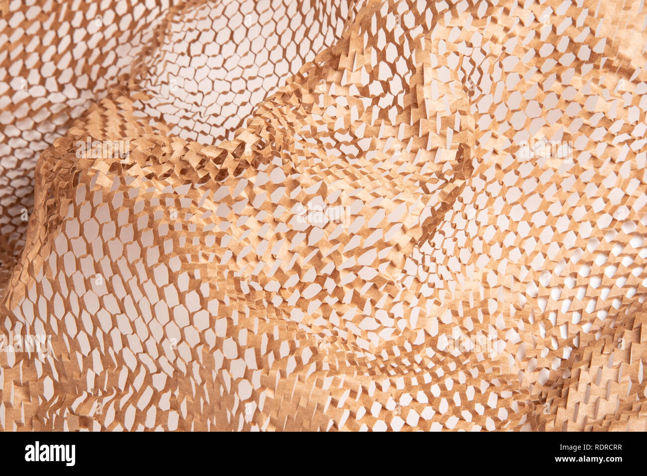 A spread of perforated brown recycled paper as packaging filler set