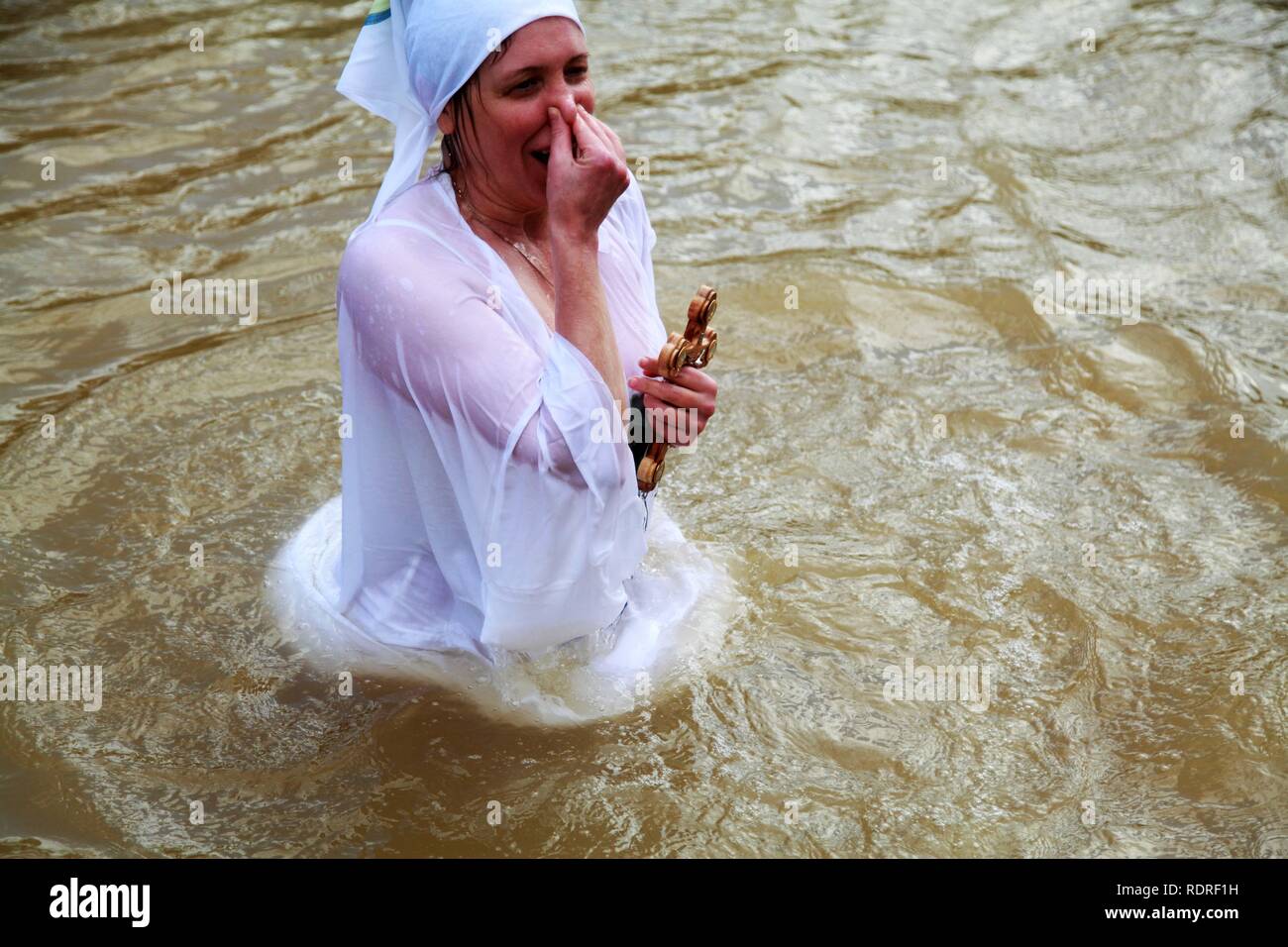 Jericho, West Bank. 18th Jan, 2019. Orthodox Christian pilgrims perform baptisms at Qasr al-Yahud baptism site on the Jordan River, during the Epiphany Day, near the West Bank city of Jericho, 18 January 2019. The ritual takes place at the site which is believed to be the place where Jesus Christ have been baptized by John the Baptist, one of the milestones in the gospel narrative of Jesus' life. Credit: Ahmad Arouri/APA Images/ZUMA Wire/Alamy Live News Stock Photo