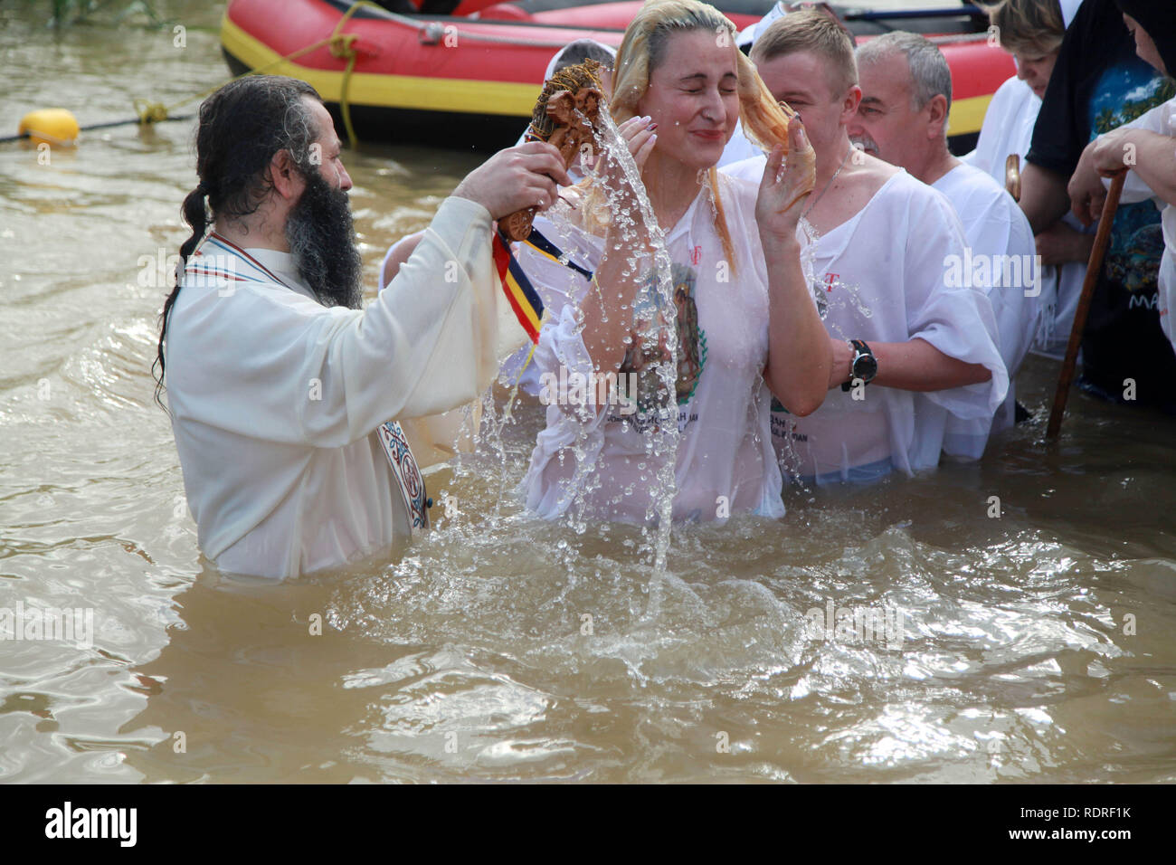 Jericho, West Bank. 18th Jan, 2019. Orthodox Christian pilgrims perform baptisms at Qasr al-Yahud baptism site on the Jordan River, during the Epiphany Day, near the West Bank city of Jericho. The ritual takes place at the site which is believed to be the place where Jesus Christ have been baptized by John the Baptist, one of the milestones in the gospel narrative of Jesus' life Credit: Ahmad Arouri/APA Images/ZUMA Wire/Alamy Live News Stock Photo