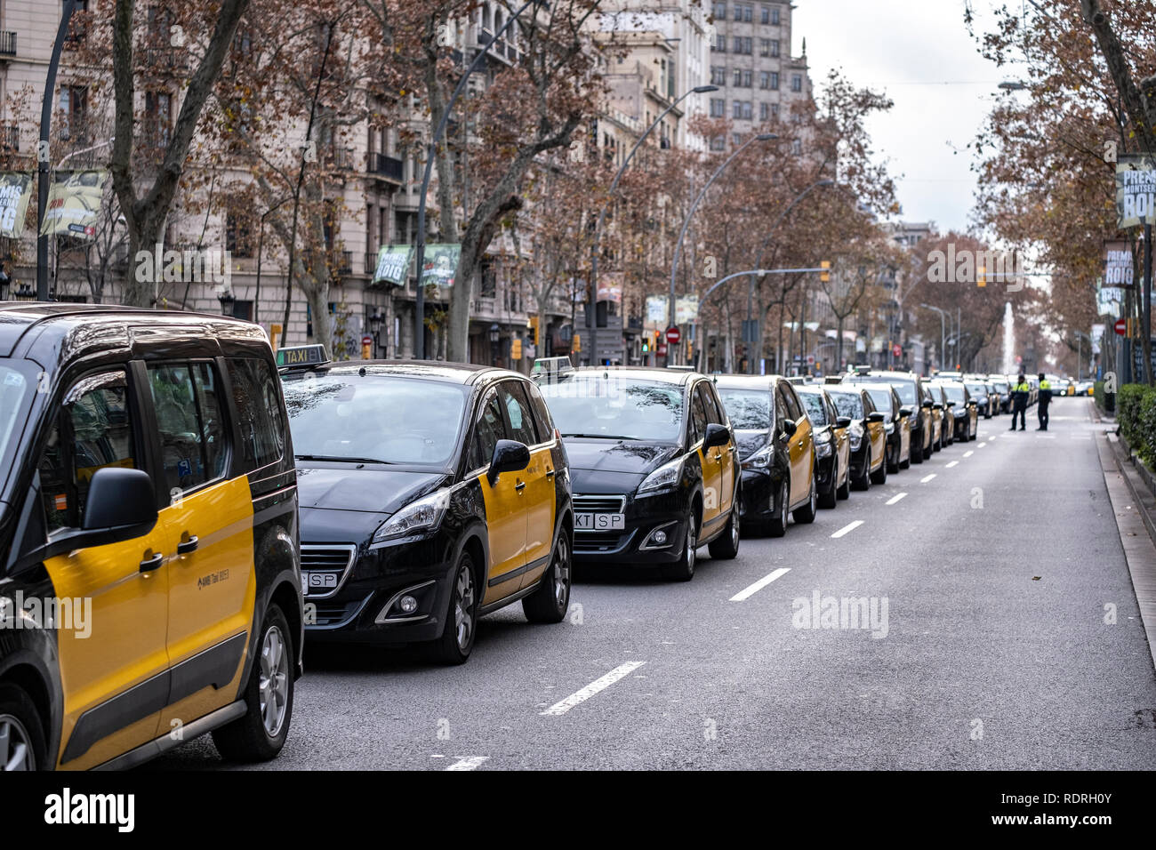 A group of taxis seen parked in a row in the center of the city of Barcelona during the protest. After broken negotiations with the Government of Catalonia, the taxi drivers of Barcelona return to the indefinite strike by occupying the Gran Vía of Barcelona. Taxi drivers have been touring the center of Barcelona in a demonstration where there have been attacks against Uber and Cabify drivers with a VTC license. Stock Photo