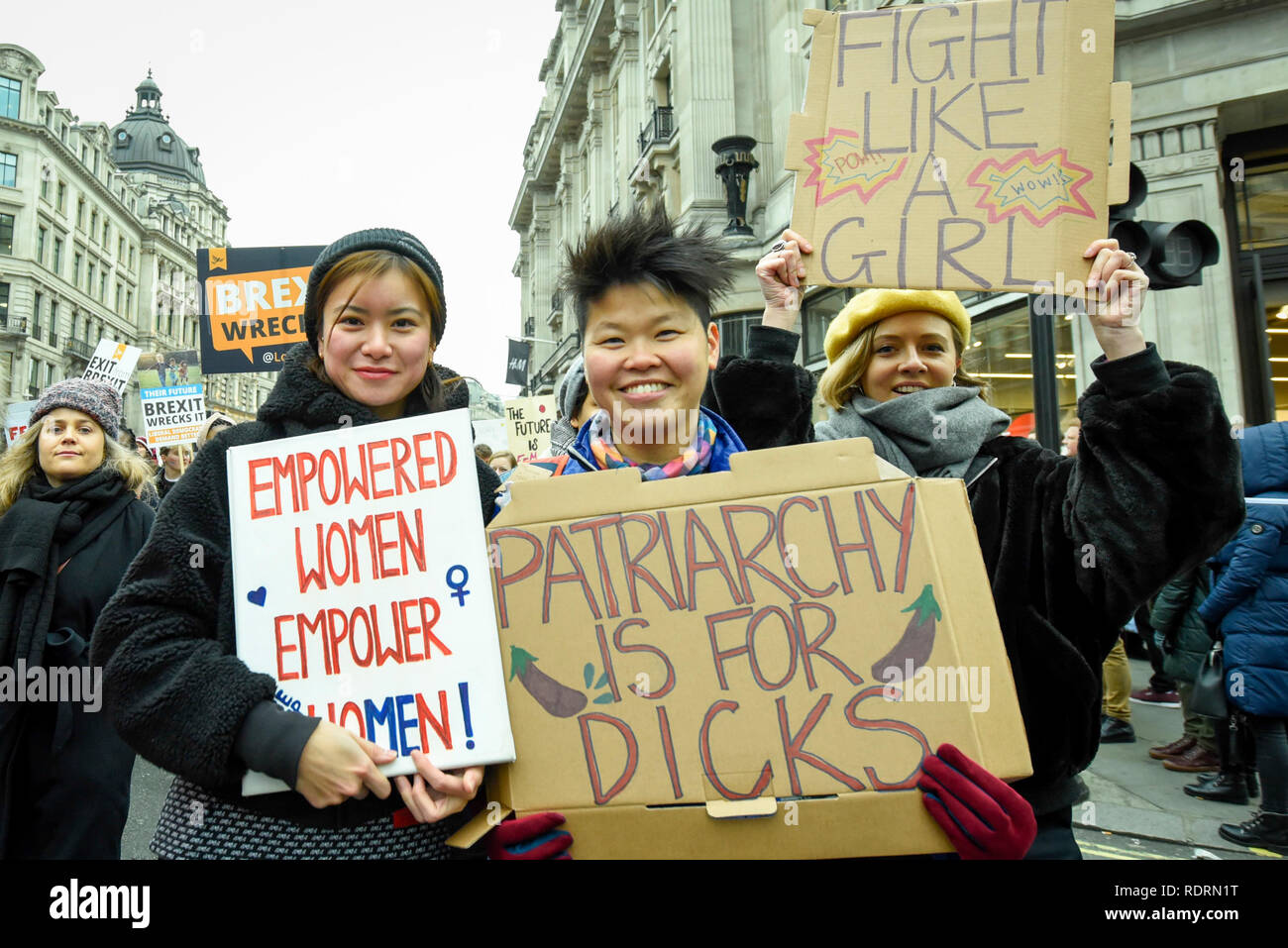 London, UK. 19th Jan, 2019. Katie Leung (L), actress, holds up a sign during the Women's March in the capital, one of 30 such worldwide marches protesting against violence against women and the negative impact of austerity policies. London's theme this year is 'Bread and Roses', honouring Polish-American suffragette Rose Schneiderman who, in 1911 said 'The worker must have bread but she must have roses too', in response to a factory fire where 146 mainly female garment workers died. Credit: Stephen Chung/Alamy Live News Stock Photo