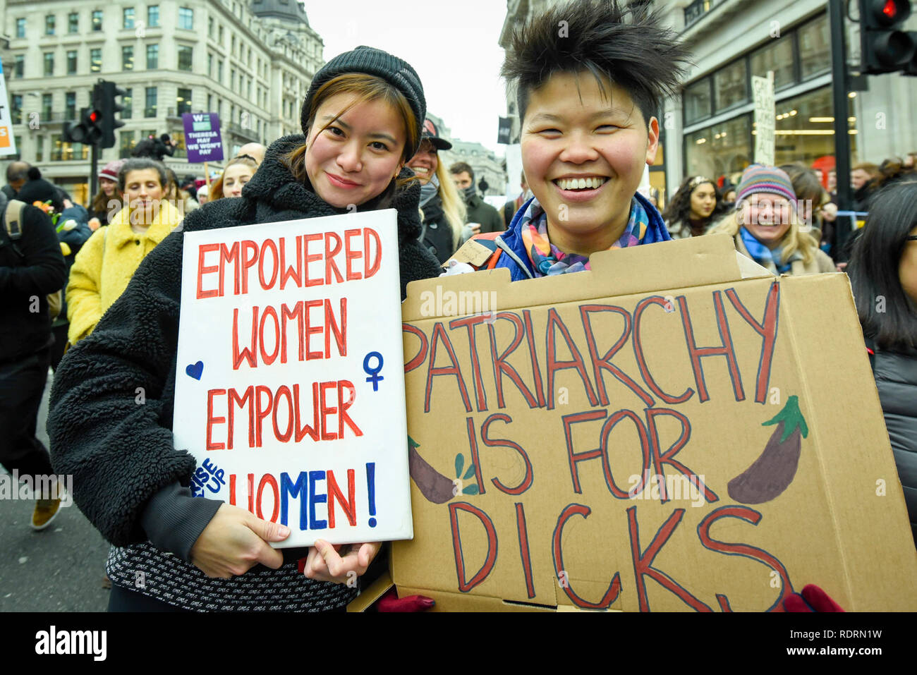 London, UK. 19th Jan, 2019. Katie Leung (L), actress, holds up a sign during the Women's March in the capital, one of 30 such worldwide marches protesting against violence against women and the negative impact of austerity policies. London's theme this year is 'Bread and Roses', honouring Polish-American suffragette Rose Schneiderman who, in 1911 said 'The worker must have bread but she must have roses too', in response to a factory fire where 146 mainly female garment workers died. Credit: Stephen Chung/Alamy Live News Stock Photo
