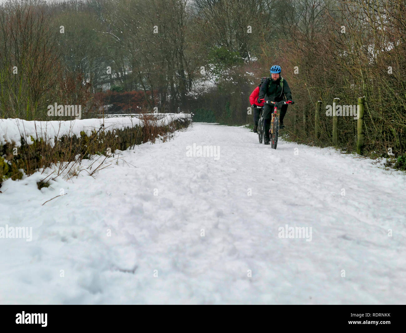 UK Weather: mountain bikers enjoying the snow conditions along the High Peak Trail, Black Rocks, Bolehill, Derbyshire, Peak District National Park Credit: Doug Blane/Alamy Live News Stock Photo