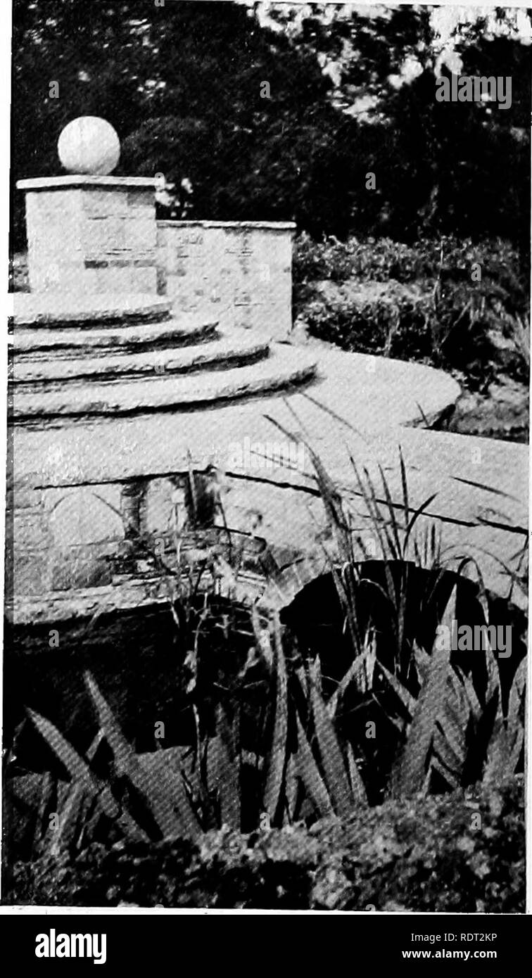. Gardens for small country houses . Gardens, English. FIG. 230.—A LITTLE WOODEN BRIDGE. ' ' appreciation of the character of the site by making the pool accord in its rough simphcity with the attractive, roughly-built cottage which it serves, and with the pump-house, which also appears in the picture. On the subject of well-heads a note of warning may be sounded. Where an actual well exists it is very desirable that its head should be made an. FIG. 231.—AT KELSALE MANOR.. Please note that these images are extracted from scanned page images that may have been digitally enhanced for readability Stock Photo