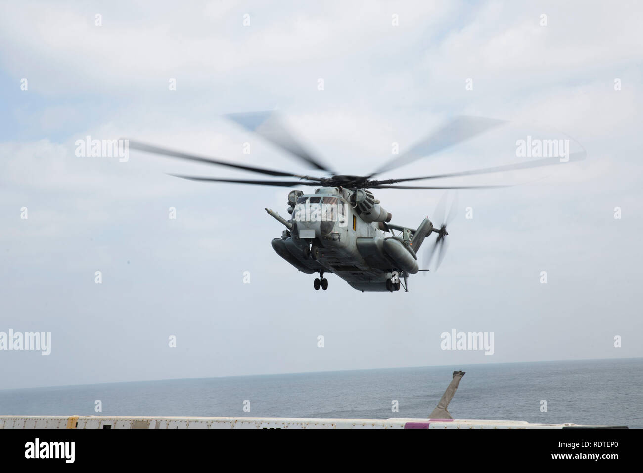 A U.S. Marine Corps CH-53E Super Stallion with Marine Medium Tiltrotor Squadron 166 Reinforced, 13th Marine Expeditionary Unit (MEU), prepares to land aboard the San Antonio-class amphibious transport dock USS Anchorage (LPD 23), Jan. 16, 2019. The Essex Amphibious Ready Group and the 13th MEU are deployed to the U.S. 5th fleet area of operations in support of naval operations to ensure maritime stability and security in the Central Region, connecting the Mediterranean and the Pacific through the western Indian Ocean and three strategic choke points. (U.S. Marine Corps photo by Sgt. Victoria D Stock Photo
