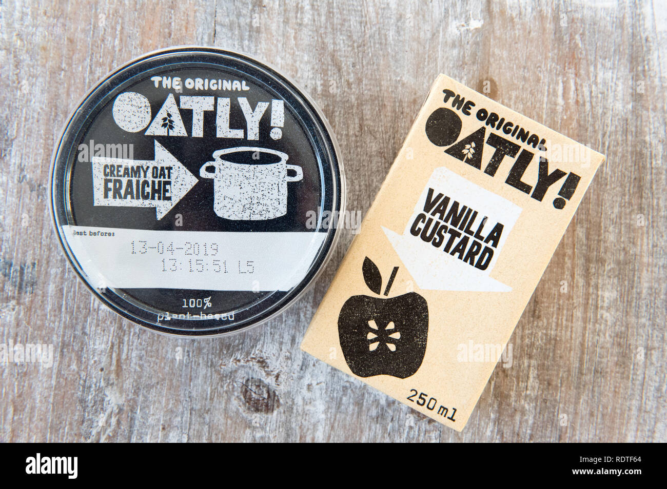 Oatly vegan Creamy Oat Fraiche and Vanilla Custard, cartons on wooden tray  Stock Photo - Alamy