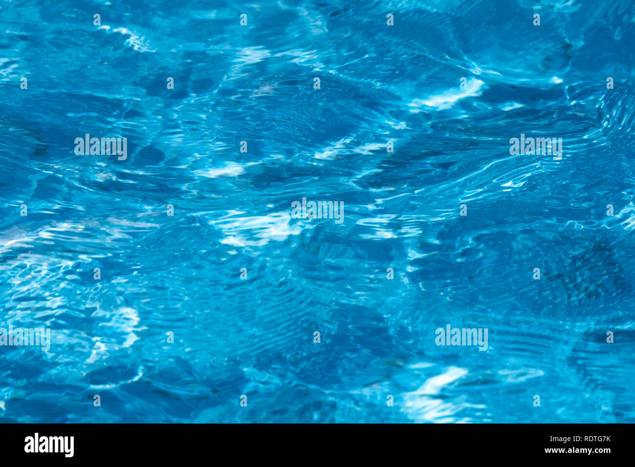 Blue and bright ripple clean water surface in swimming pool with sun ...