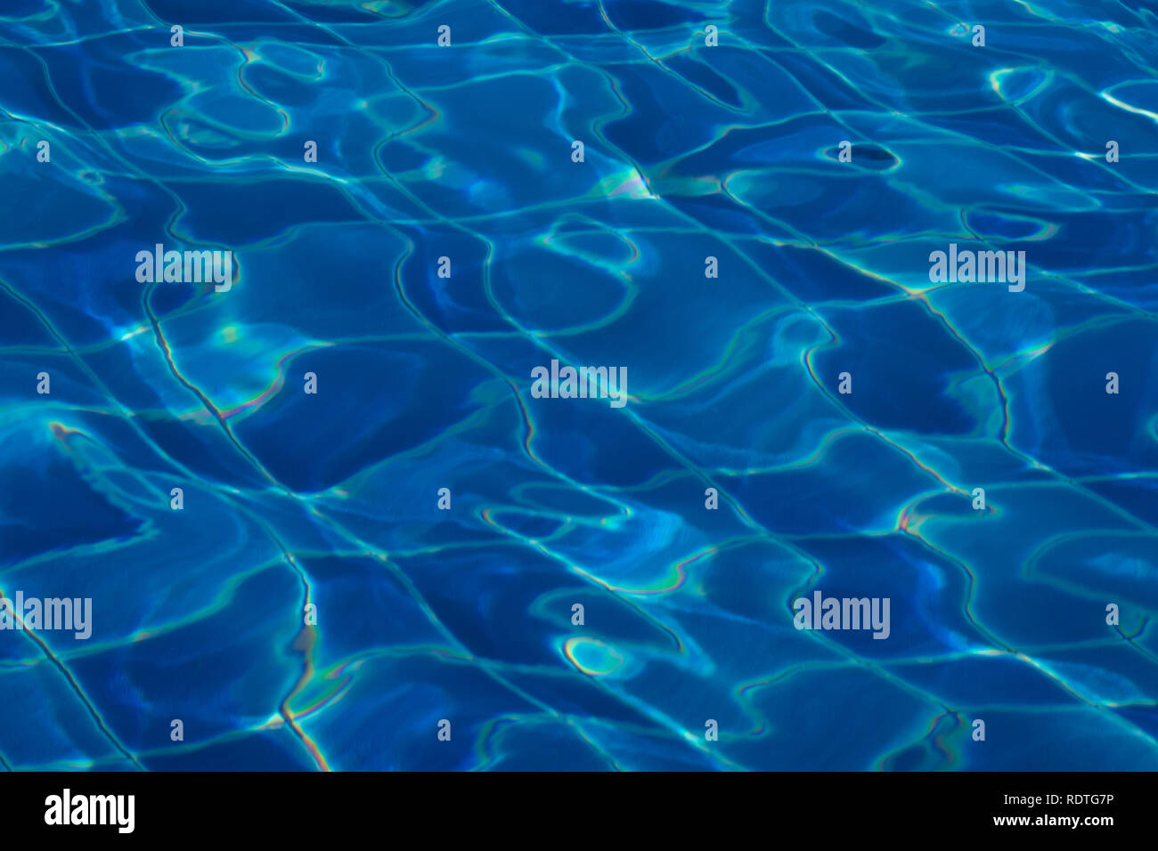 Blue and bright ripple clean water surface in swimming pool with sun ...
