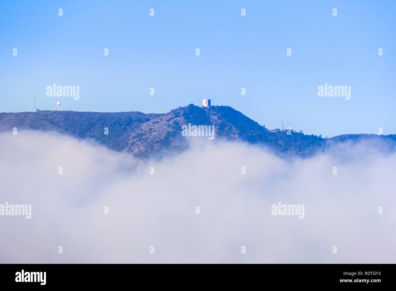 Mount Umunhum rising above the clouds, south San Francisco bay area, Santa Clara county, California Stock Photo
