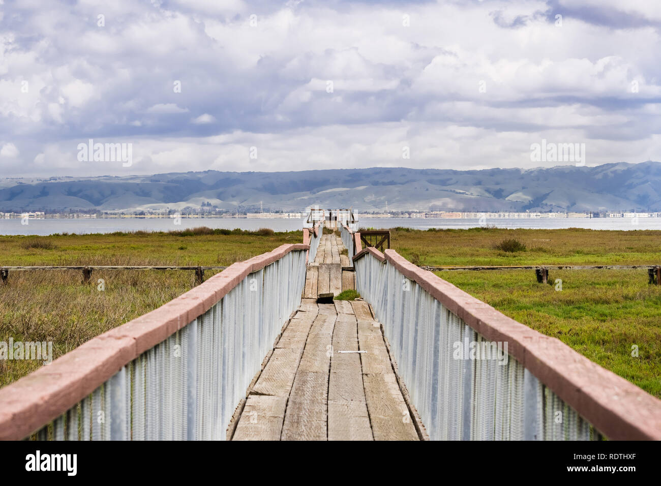 Damaged wooden boardwalk going over the marshes of south San Francisco bay area, Palo Alto Baylands Park, California Stock Photo