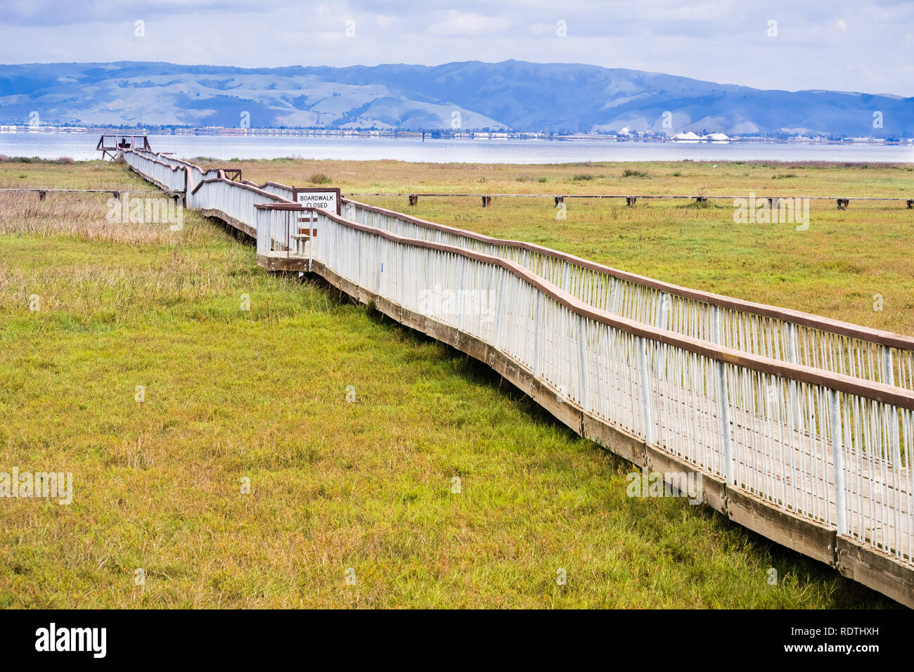 Damaged wooden boardwalk going over the marshes of south San Francisco bay area, Palo Alto Baylands Park, California Stock Photo