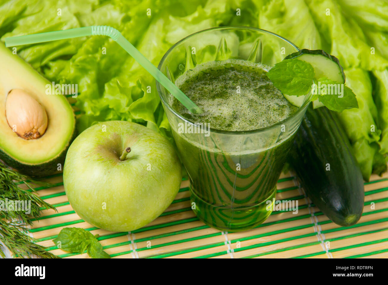 Healthy green smoothie with ingredients on wooden background. Stock Photo