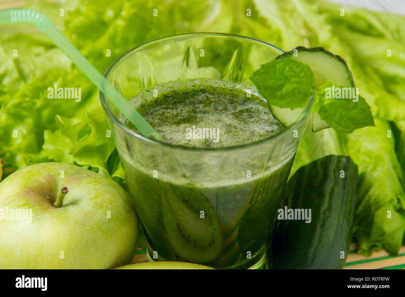 Healthy green smoothie with ingredients on wooden background. Stock Photo