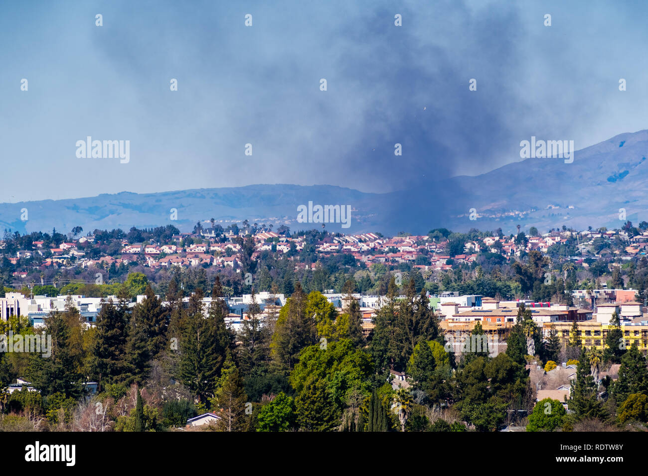 Smoke from a fire rising over residential areas in south San Jose, San Francisco bay area, California Stock Photo