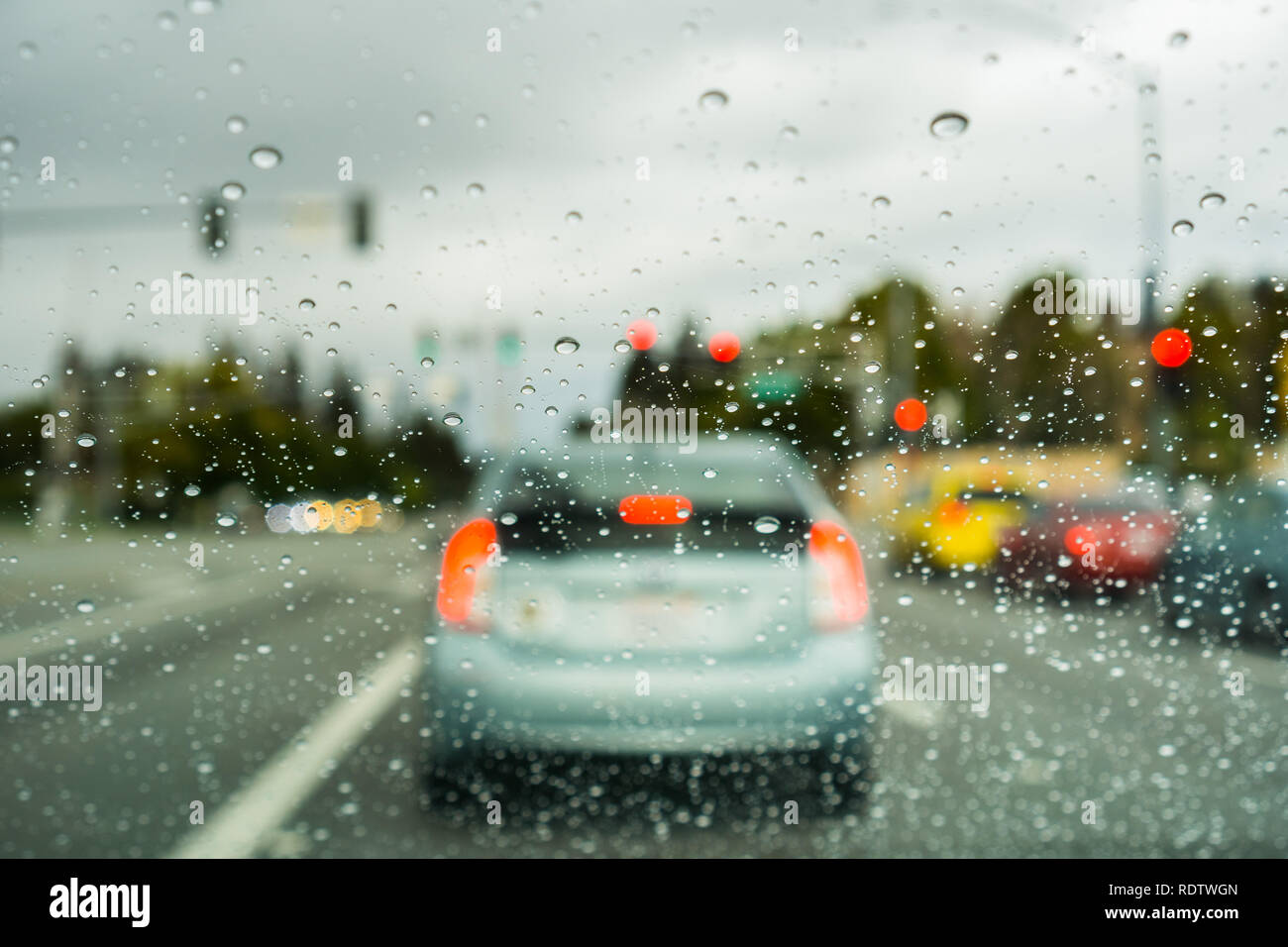 Cars stopped at a red light on a rainy day, California Stock Photo - Alamy