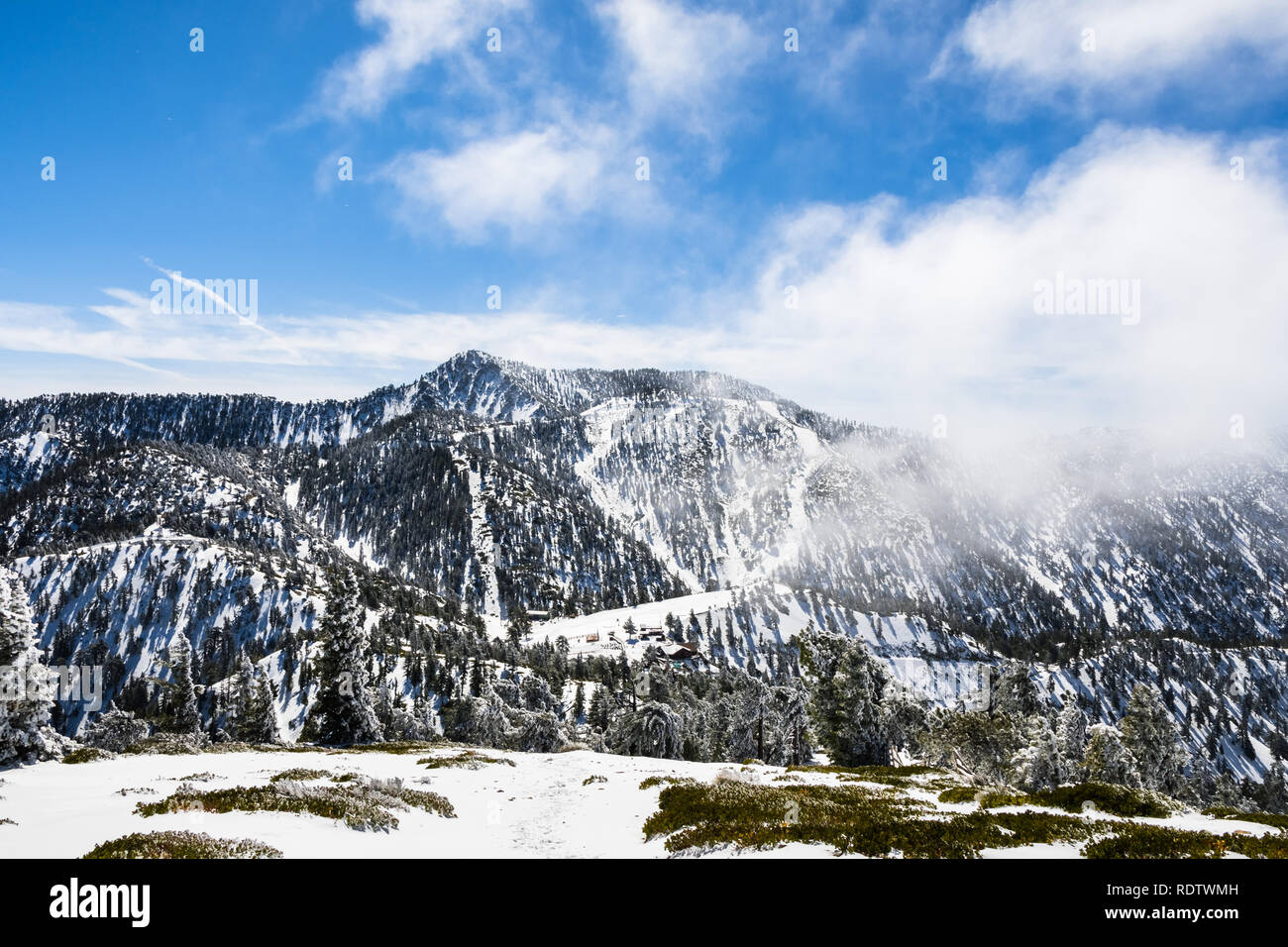 Ski slopes on Mount San Antonio (Mt Baldy), fog rising up from the valley, south California Stock Photo