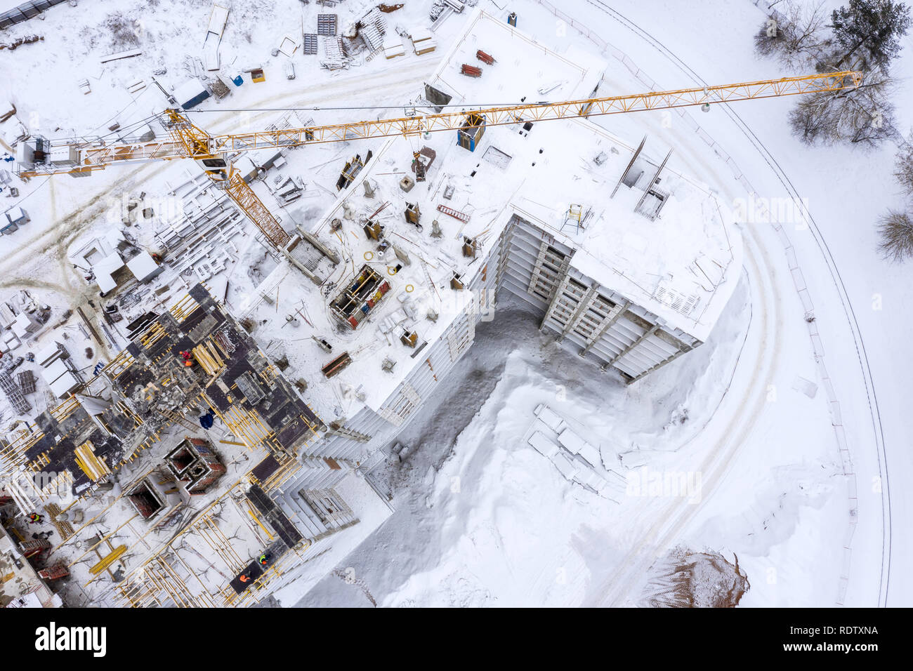 high yellow tower crane working at a construction site. building of new ...