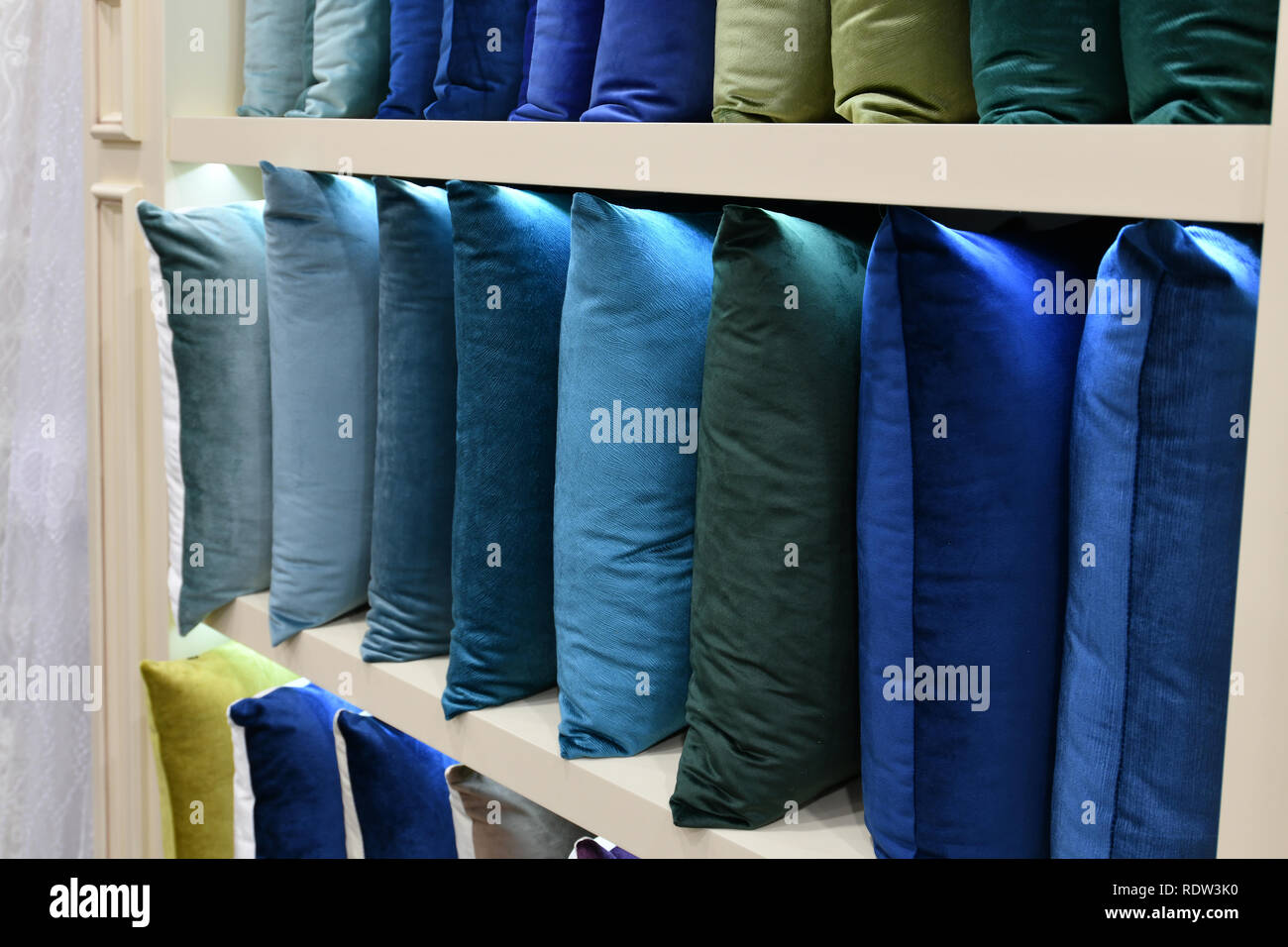 Many decorative pillows on the shop window Stock Photo