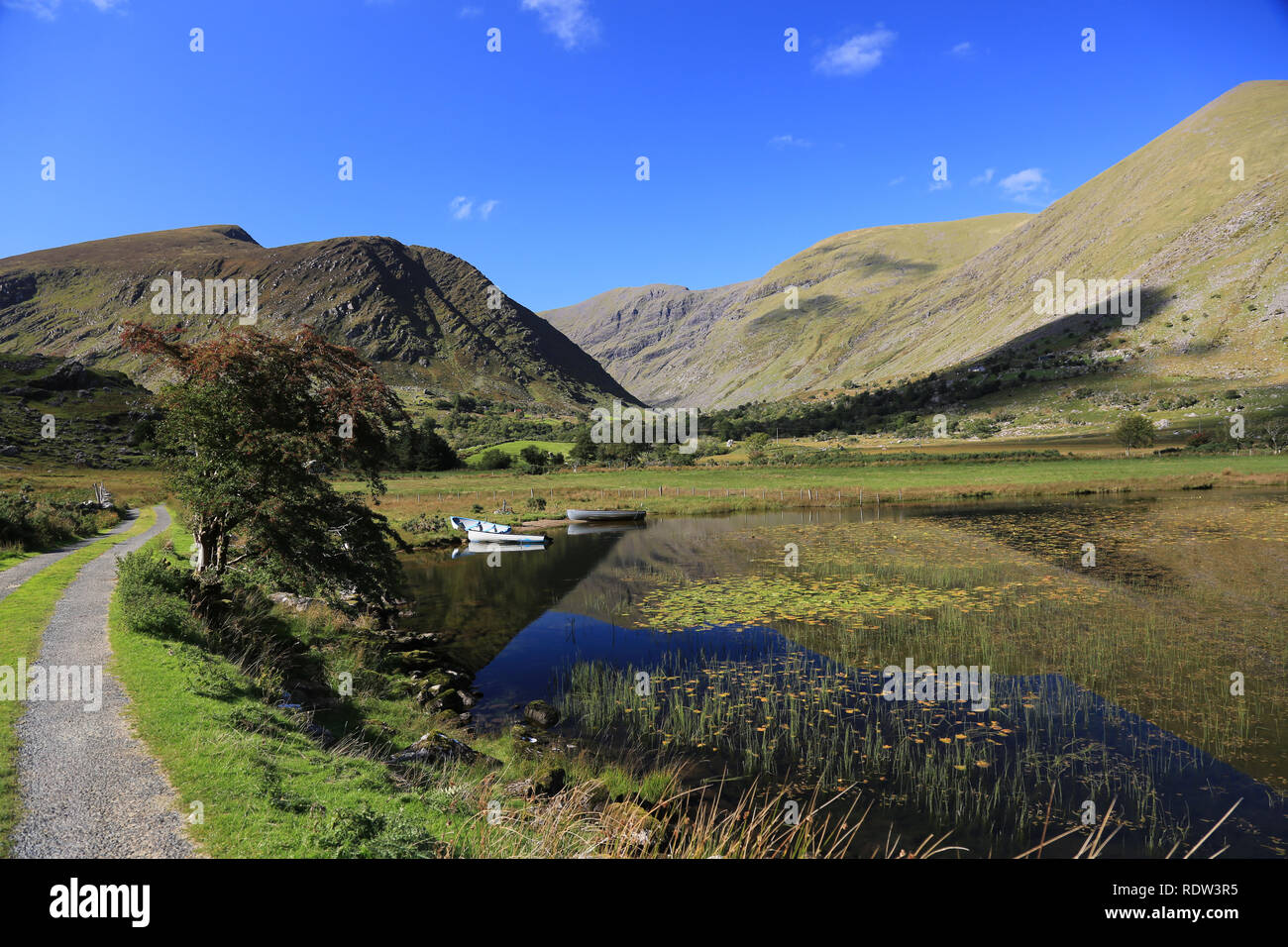 calm waters of lake hidden under the shadows of irelands highest mountain, black, valley, county kerry, irerland Stock Photo