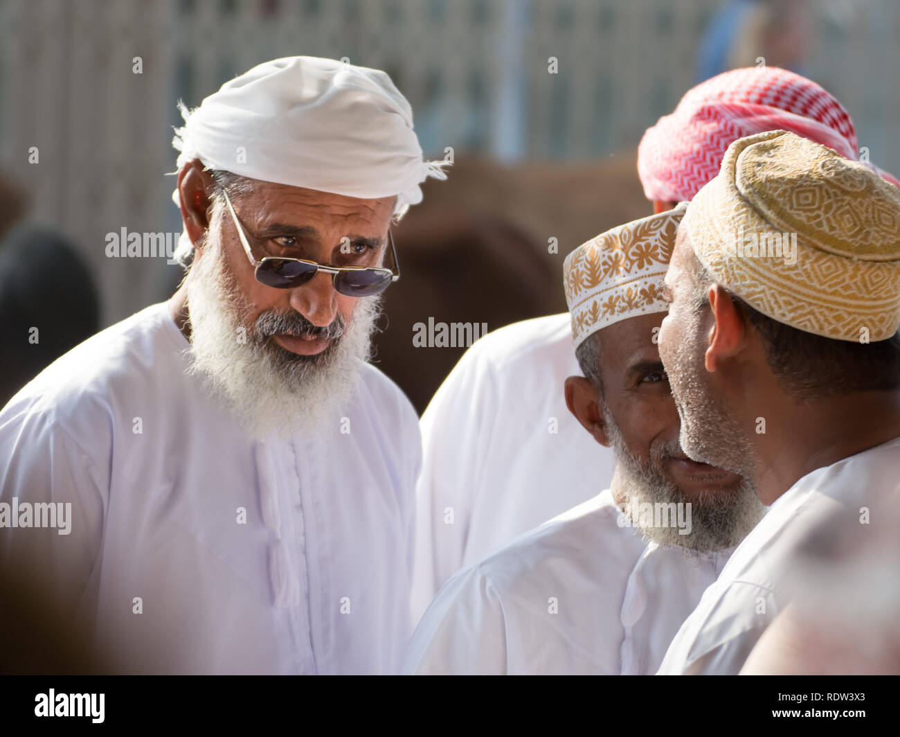 Nizwa, Oman - November 2, 2018: An expression of an Omani man who discusses with other men at the Friday market in Nizwa Stock Photo