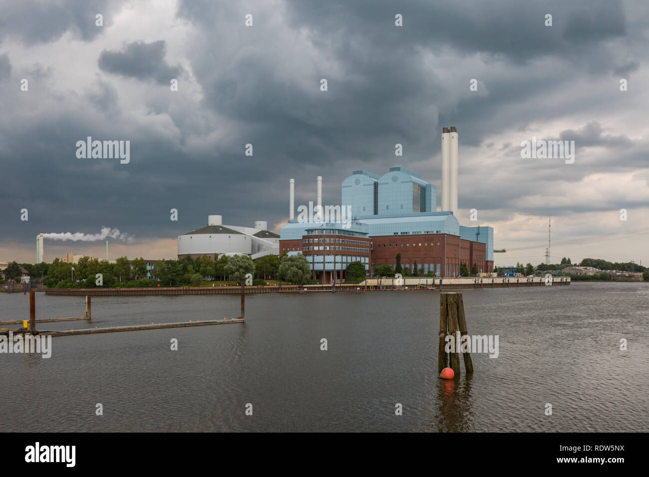 Dark clouds over the power plant on the river Elbe in Hamburg Stock Photo