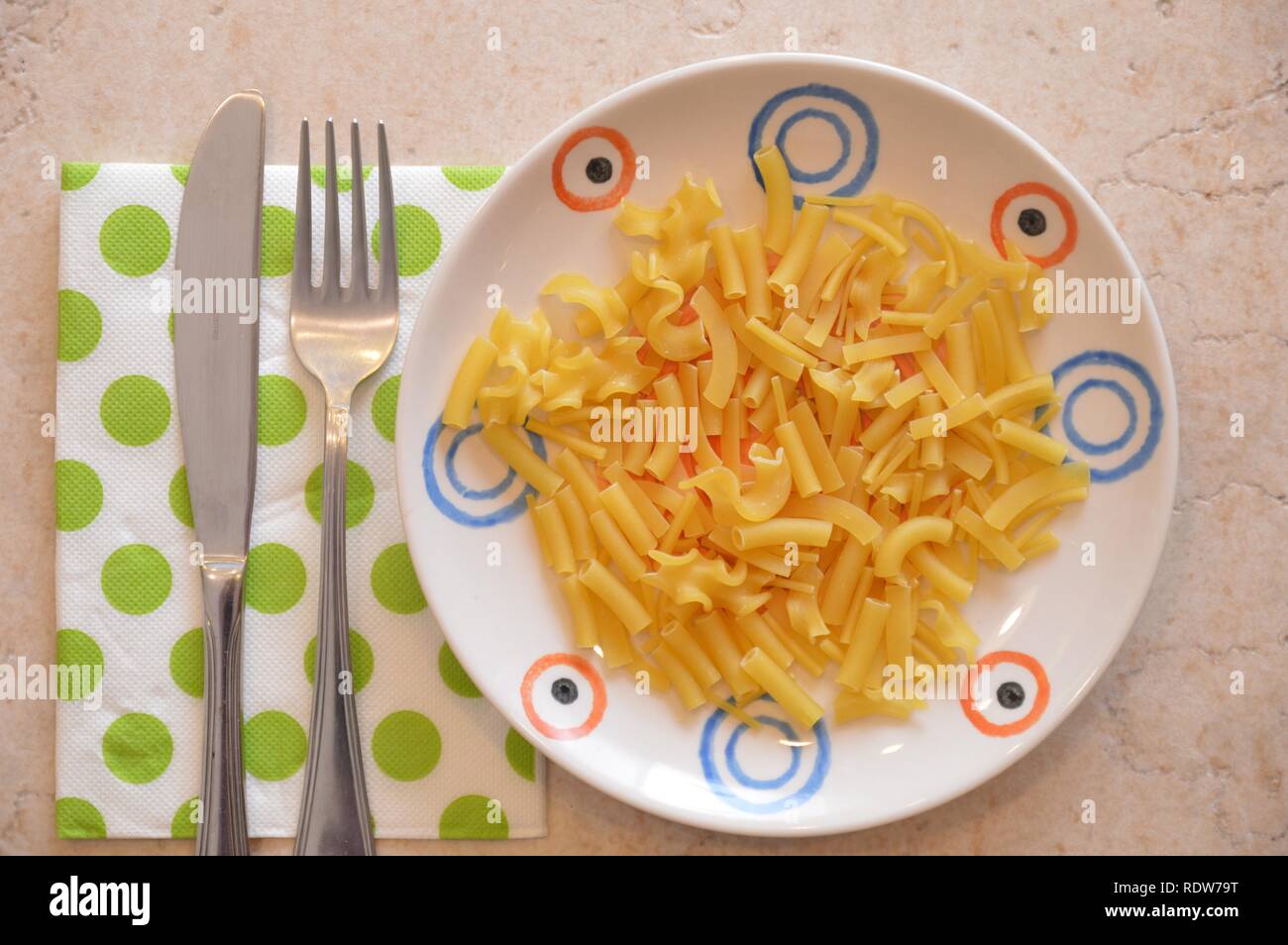 italian pasta in plate with metal fork and spoon Stock Photo Alamy