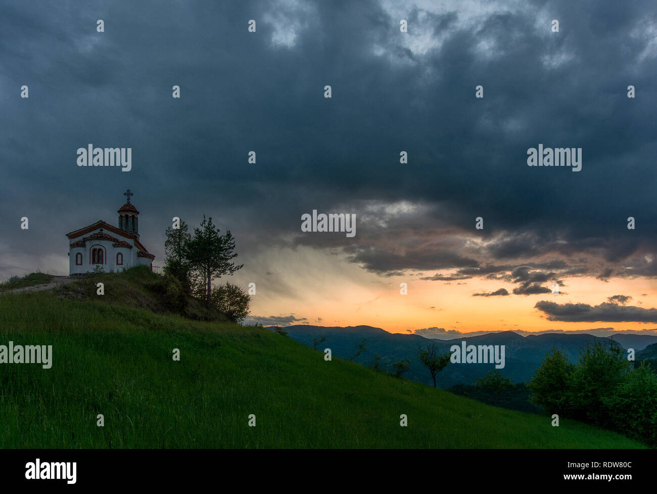 Small chapel on the hill in Rhodope mountain near Borovo village and Krastova gora, Golden sunset. Photo from Bulgaria Stock Photo