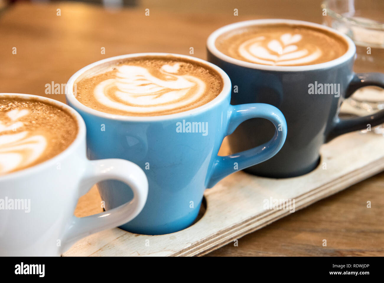 Flat white flight featuring Bomber Blend, Wush Wush, and El Recuerdo. The Flight Coffee Hangar is a cafe serving house-brewed coffee, sandwiches & lig Stock Photo