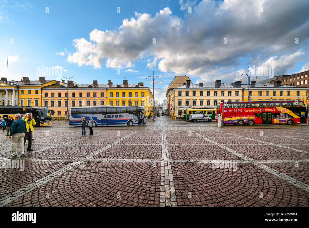 Tour busses line up at the Senate Square in Helsinki Finland with the  restored Sofiankatu Street in view. Stock Photo