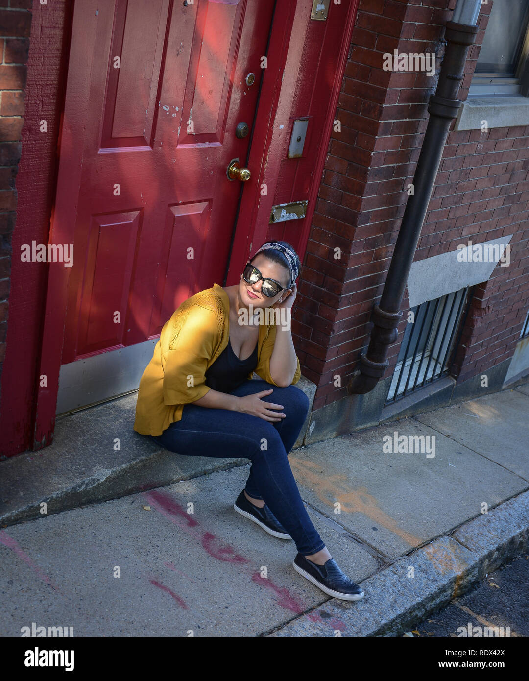 Young Woman On The Street Drinking Coffee And Siting On The
