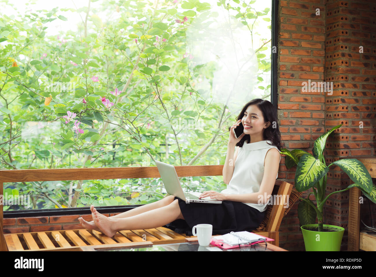 Confident young asian woman in smart casual wear talk on phone. Stock Photo