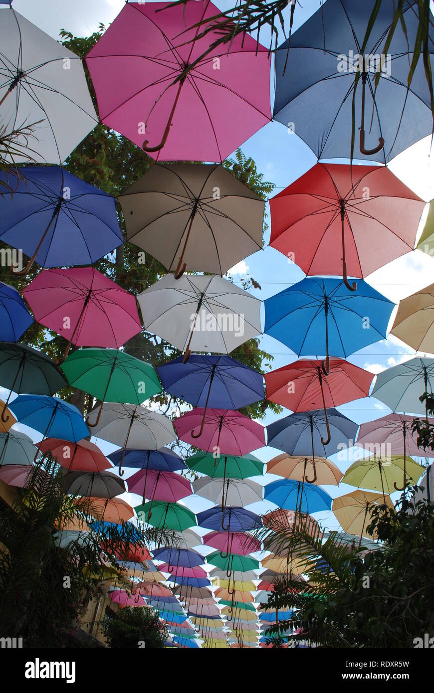 Multi-colored open umbrellas provide shade for a narrow street on the Turkish side of Nicosia, Cyprus Stock Photo