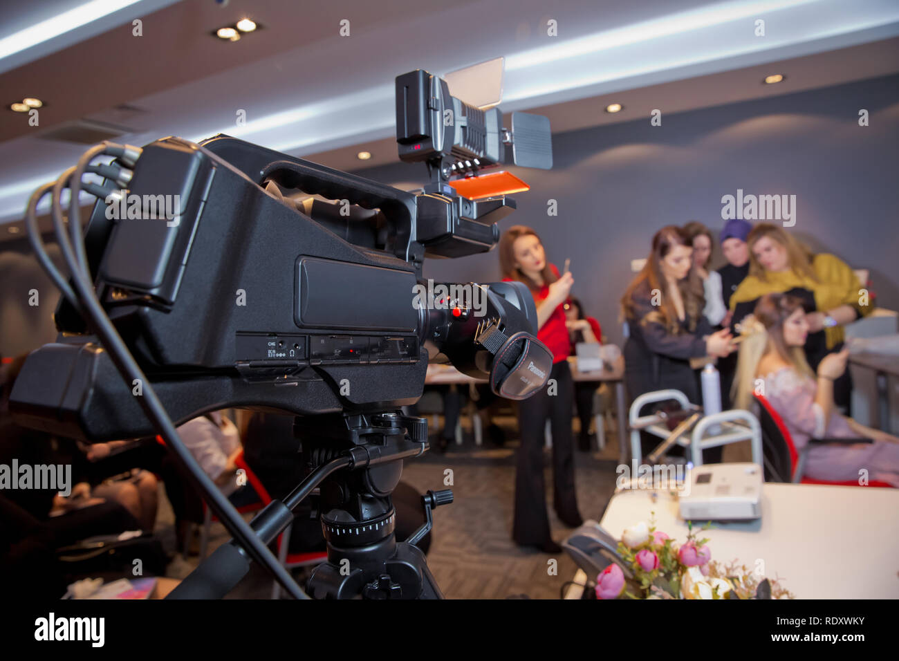 Makeup cosmetic at home. Focus on tripod mounted Video camera screen showing . In front of the camera to recording vlog video live streaming at home.B Stock Photo