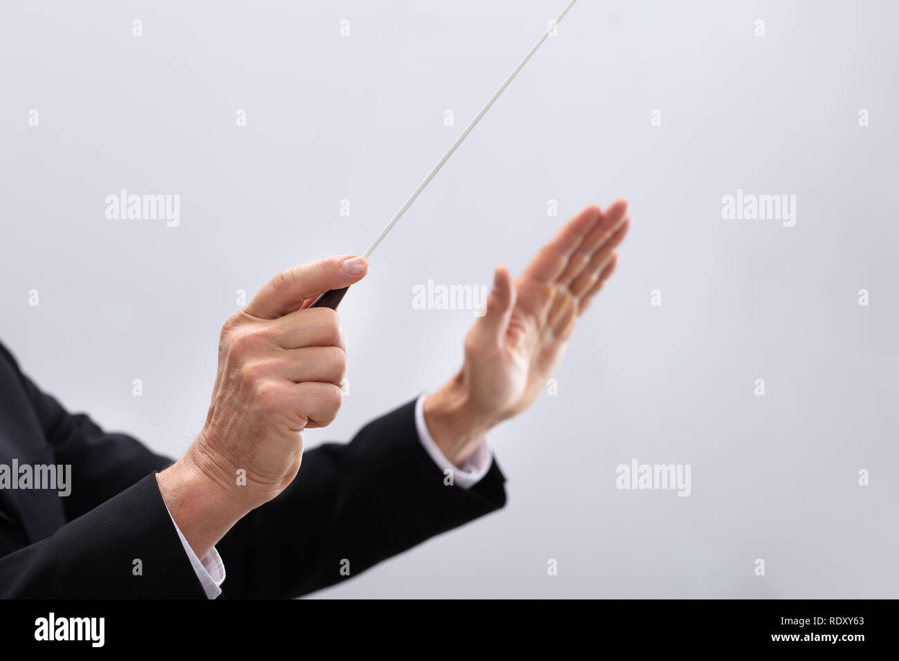 Close-up Of A Person's Hand Directing With Conductors Baton Stock Photo