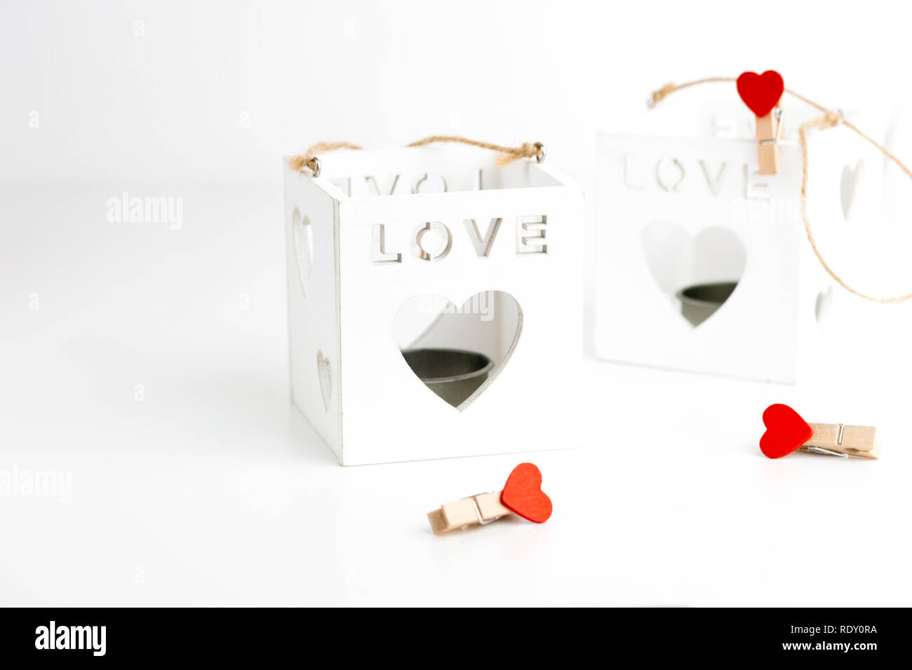 Two cube candlesticks on white with hearts. Valentines Day concept. Stock Photo
