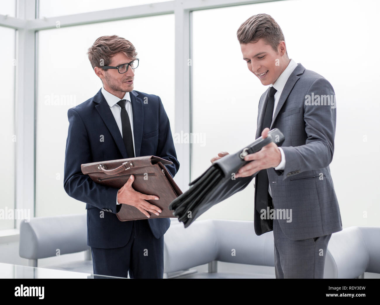 two businessmen standing in the office Stock Photo - Alamy