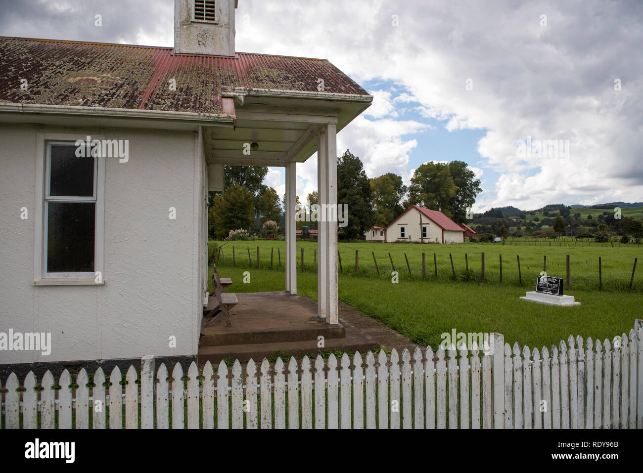 A church in Mangamuka with a Maori meeting house in the background in