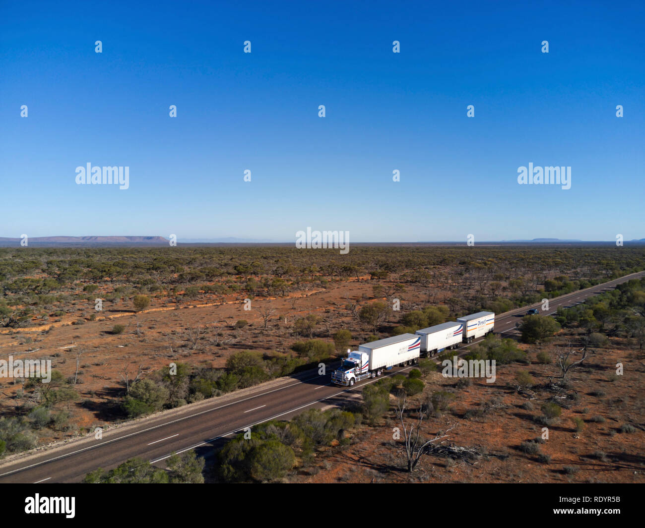 Aerial of triple trailer roadtrain on the Stuart Highway in the arid outback of South Australia Stock Photo