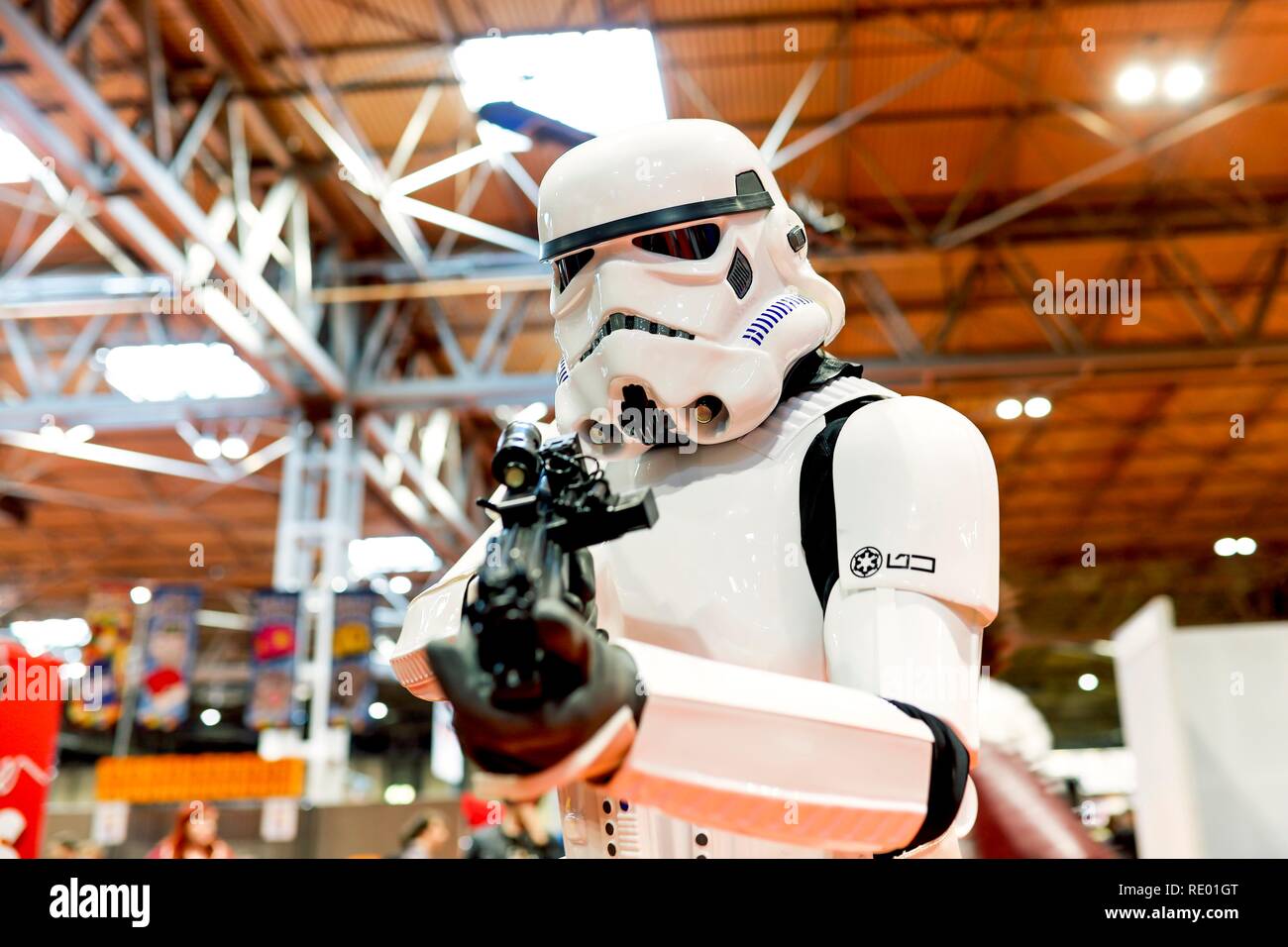 Birmingham, UK - March 17, 2018. A cosplayer dressed in a Storm Trooper costume from Star Wars movies at a comic con in Birmingham, UK pointing a gun Stock Photo
