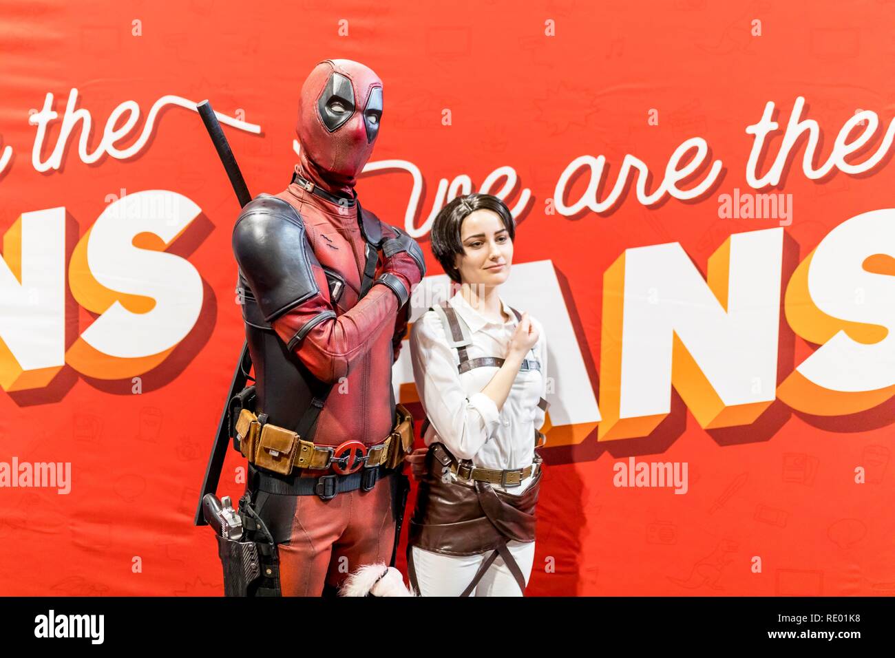 Birmingham, UK - March 17, 2018. Young boy comicon fan poses pointing gun with Marvel Comics character Deadpool in cosplay fancy dress at a comic conv Stock Photo