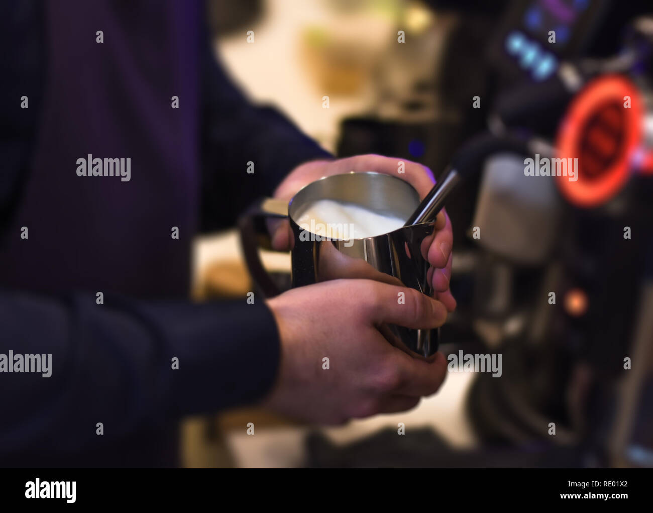 Steaming milk barista making beautiful creamy millk for perfect cup of espresso Stock Photo