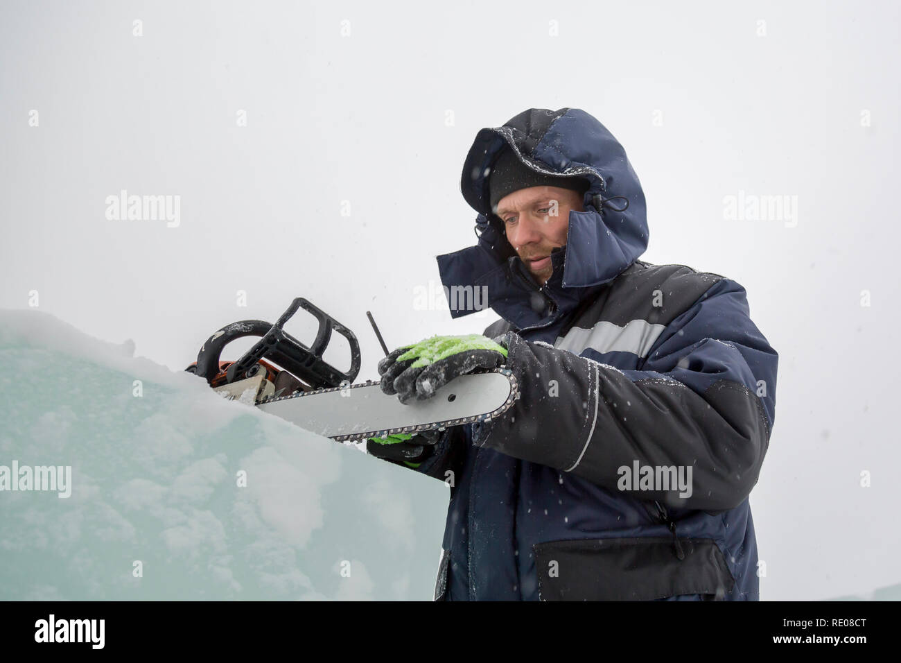 A manual file worker sharpens a chainsaw chain Stock Photo
