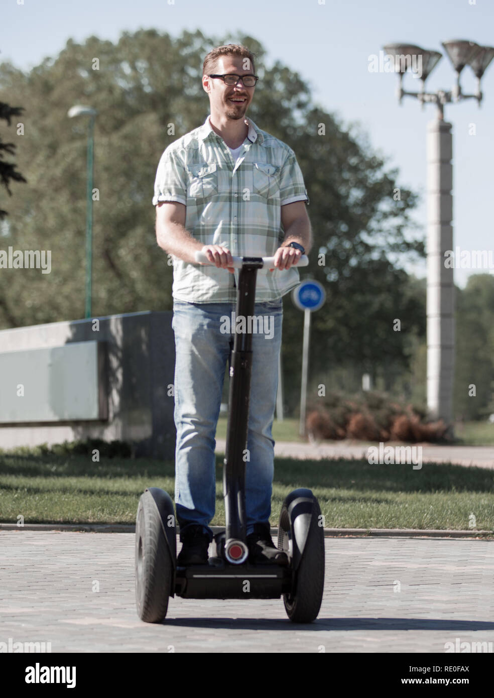 happy modern man riding a mini hoverboard in the Park Stock Photo - Alamy