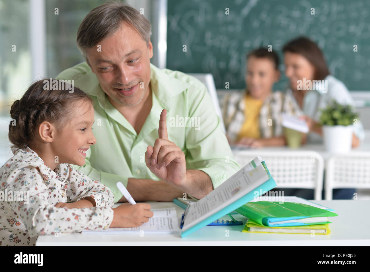 Portrait of father helps his cute little daughter Stock Photo